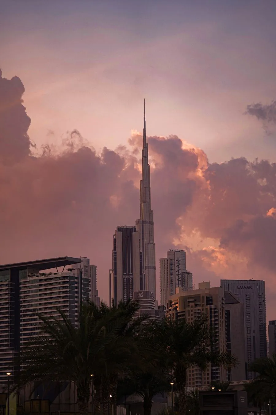 The Burj Khalifa rising above Downtown Dubai beneath pink evening clouds