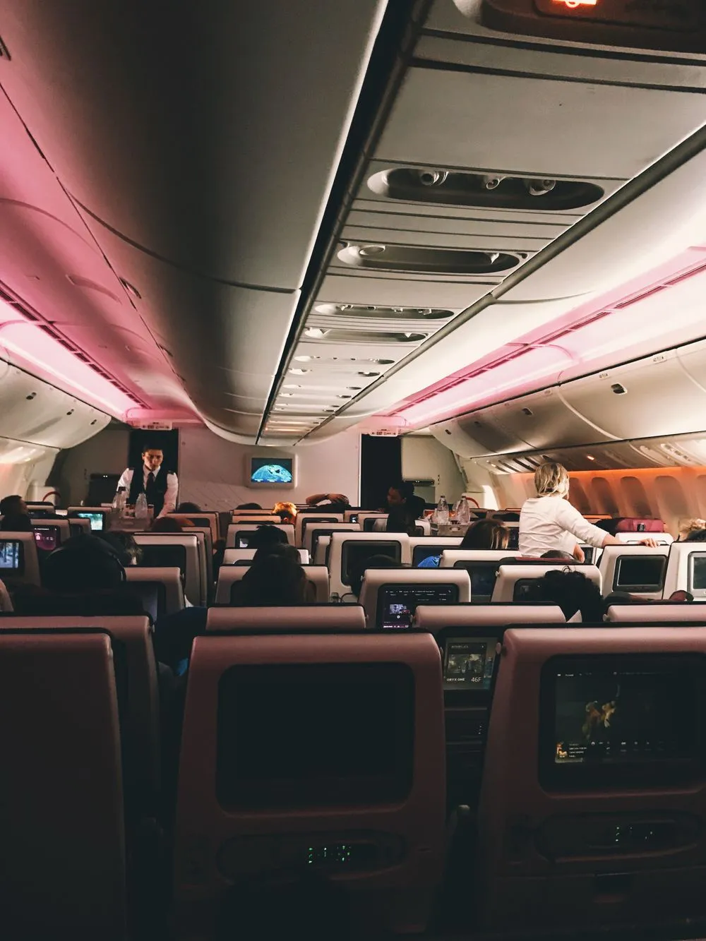 Cabin crew serving passengers in a business class cabin