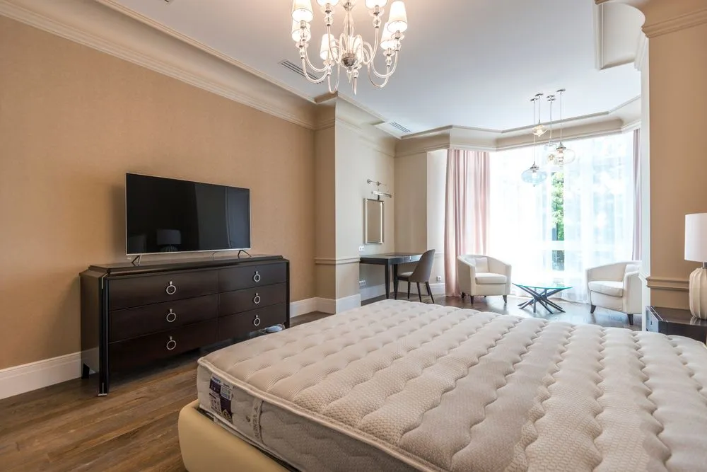 Spacious hotel suite with a large bed and seating area