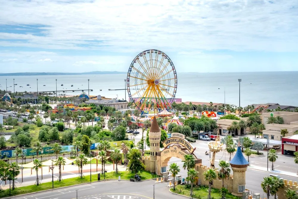 Seaside theme park with a large Ferris wheel