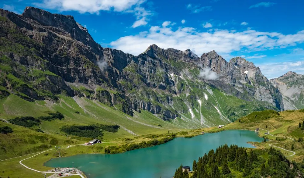 Alpine lake surrounded by steep green mountains in Switzerland