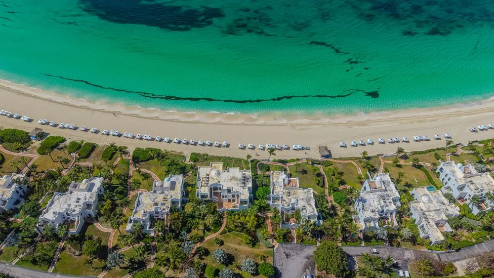 Aerial view of a turquoise bay and beachfront resort