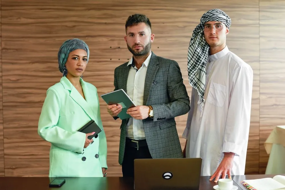 Three travel consultants standing together in an office